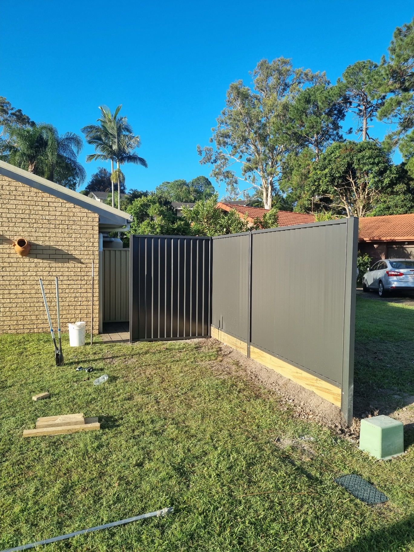 Dark Colorbond fence and matching gate ready for handover — Ridgeback Fences install.