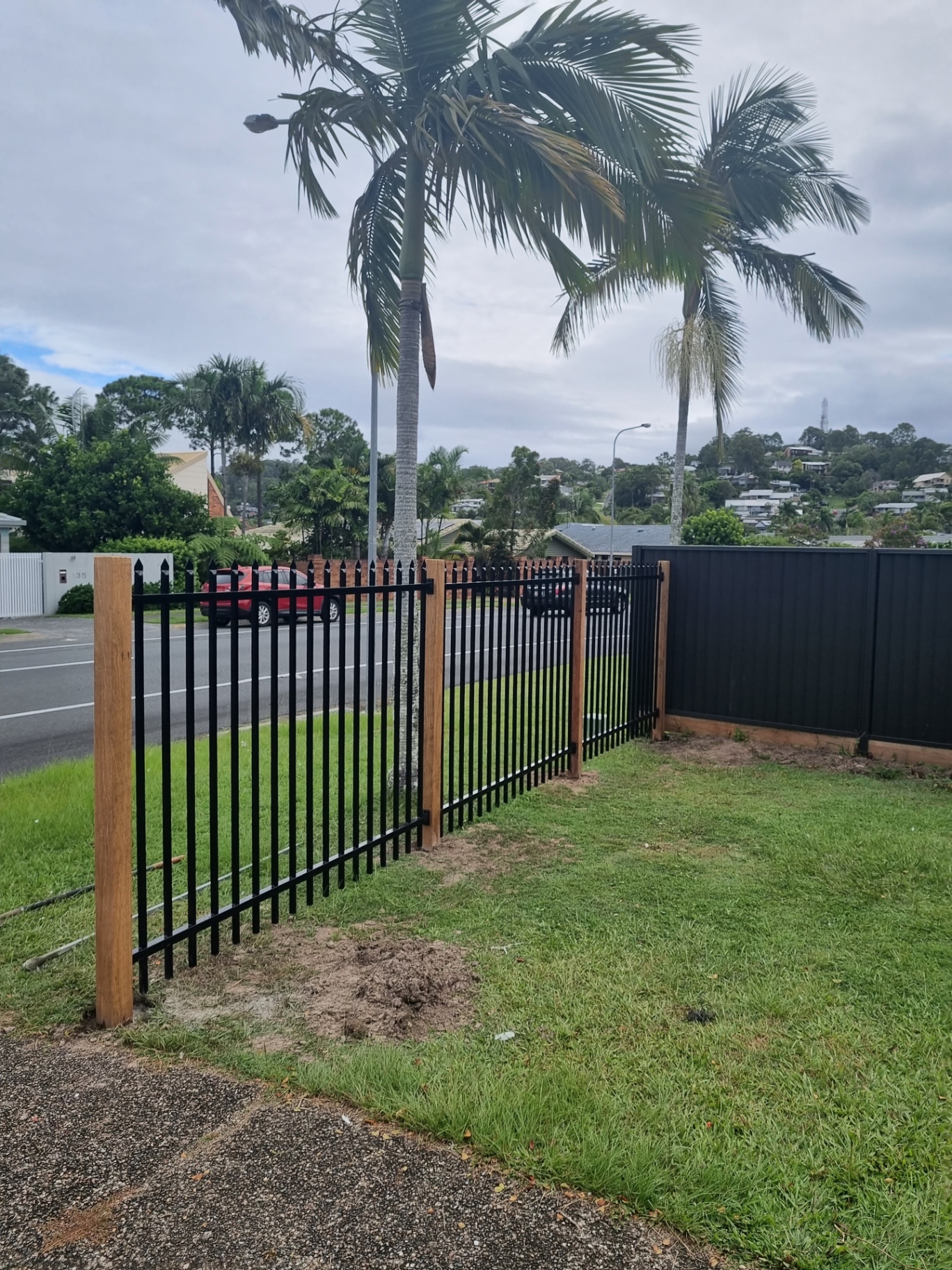 Black steel spear-top security fence with hardwood posts installed by Ridgeback Fences.